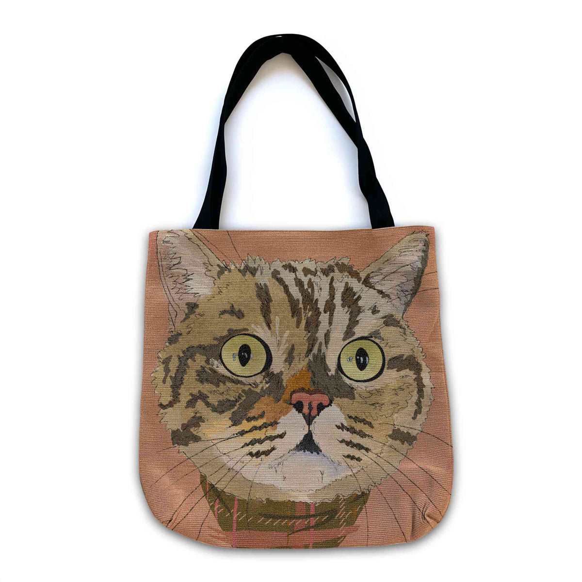 A woven tote bag with black shoulder straps featuring a custom illustrated cat portrait of a tabby cat wearing a plaid bandana set against a subtle textured orange background printed on the side of the bag, shown on a clean white background. 