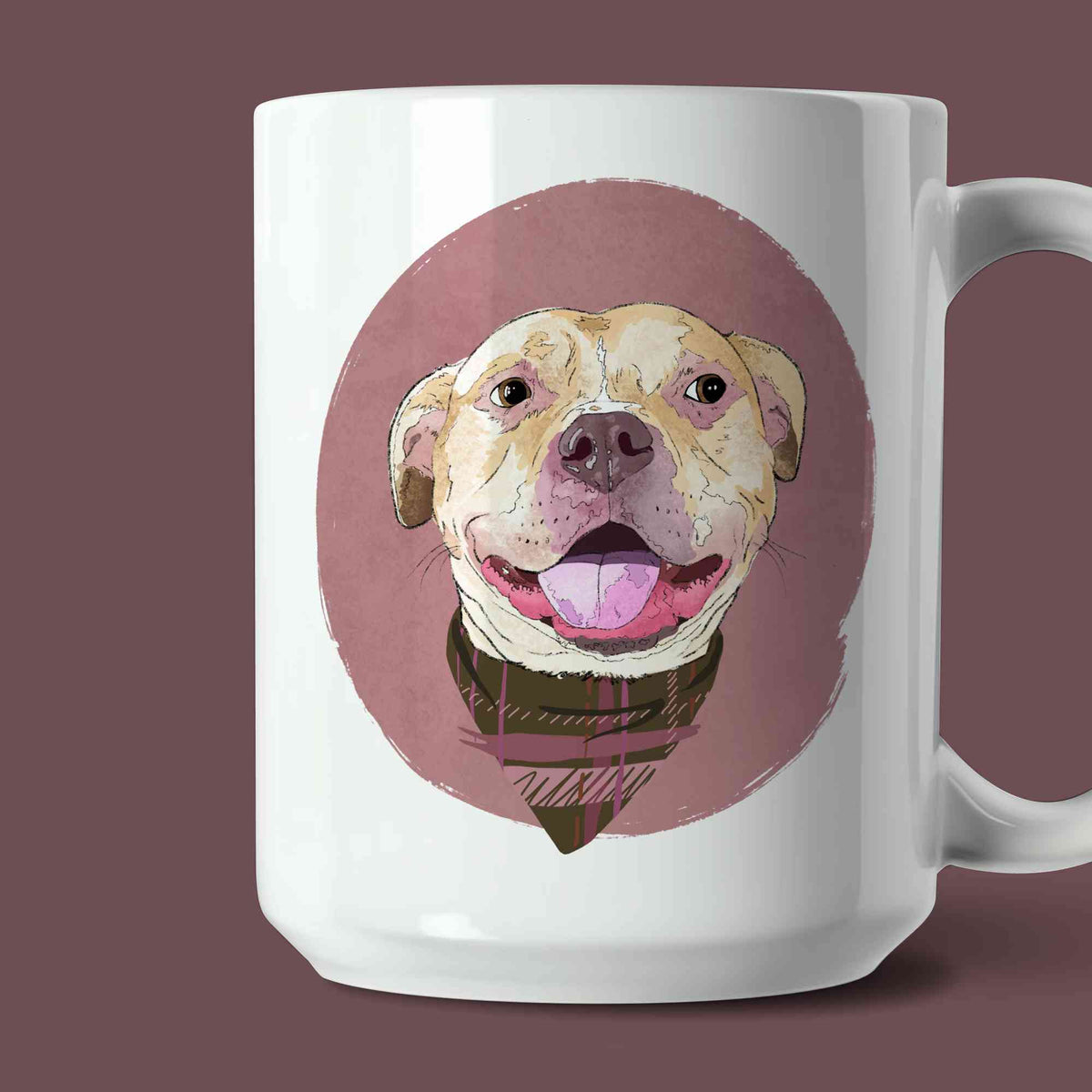 A white ceramic coffee mug featuring a custom illustrated dog portrait of a smiling tan dog wearing a plaid bandana set against a subtle textured dusty rose circular background printed on the side of the mug, shown on a dusty rose background. 